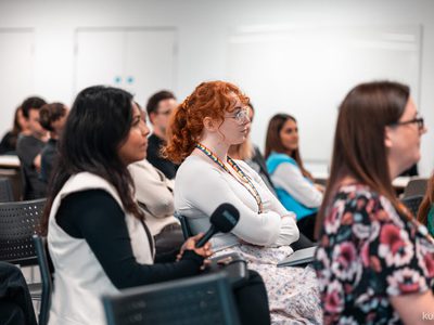 Females in a room watching preso