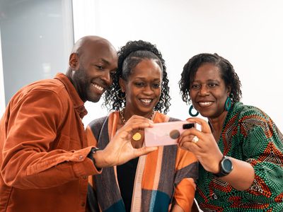 Three african american people smiling at camera